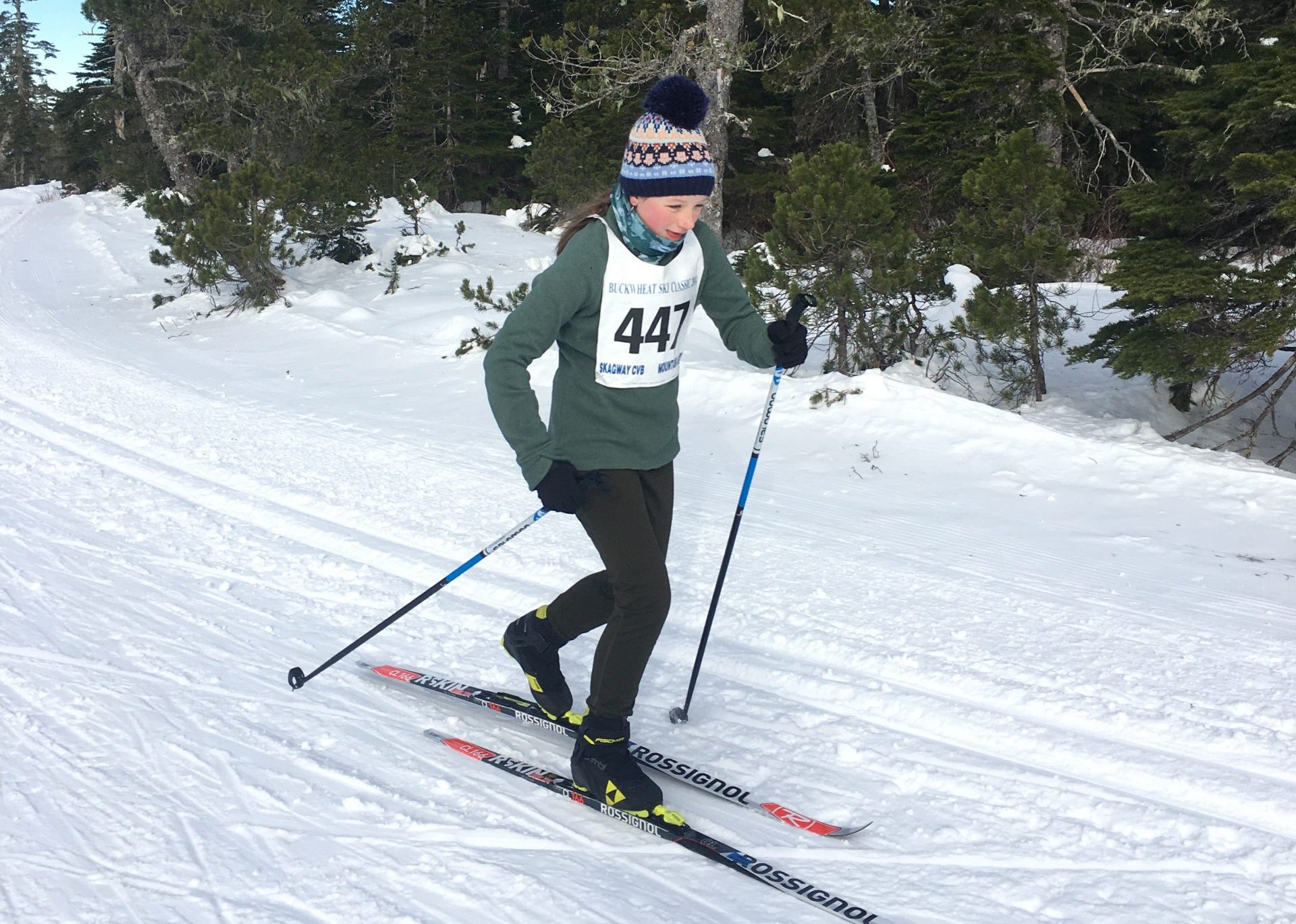 young female skier classic skiing mid-stride