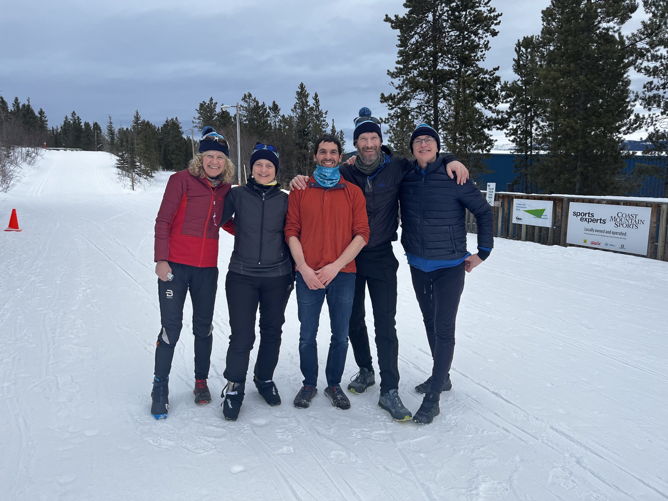 IMG_7308 a group of five adults standing in ski gear outside smiling
